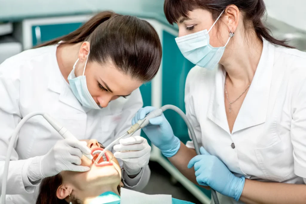 A patient receiving dental cleaning at a clinic